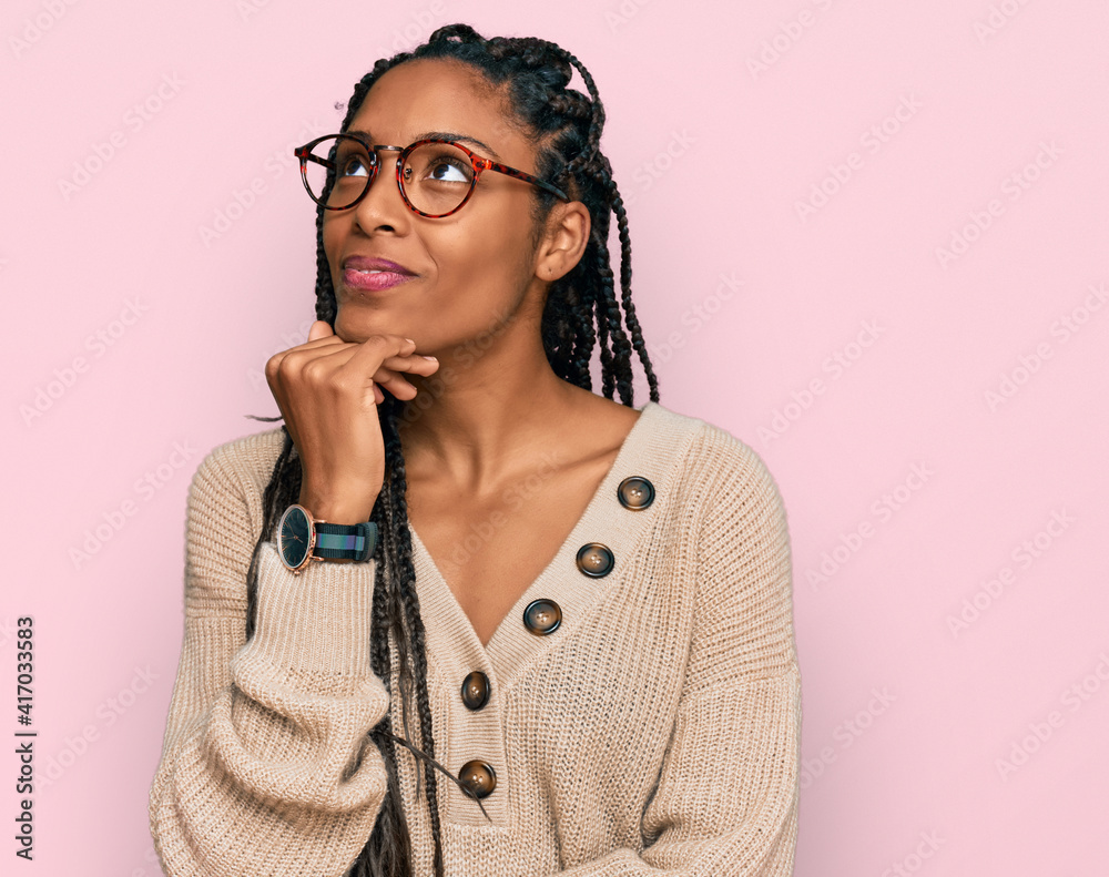 African american woman wearing casual clothes with hand on chin thinking about question, pensive expression. smiling and thoughtful face. doubt concept. African american woman wearing casual clothes with hand on chin thinking about question, pensive expression. smiling and thoughtful face. doubt concept.