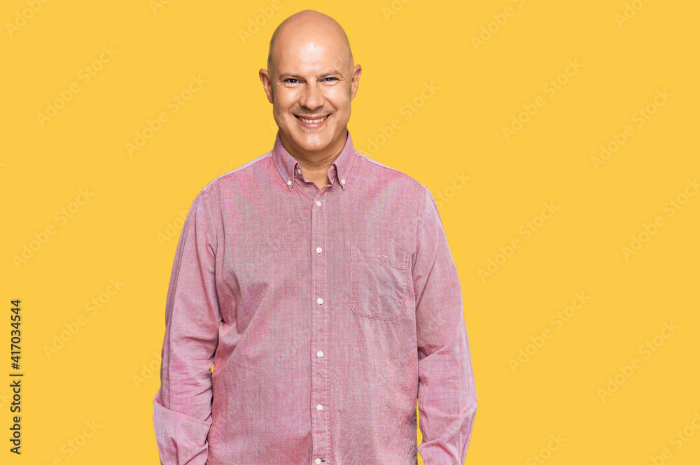 Middle age bald man wearing casual clothes with a happy and cool smile on face. lucky person. Middle age bald man wearing casual clothes with a happy and cool smile on face. lucky person.