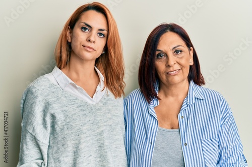 Obraz na plátně Latin mother and daughter wearing casual clothes thinking attitude and sober exp