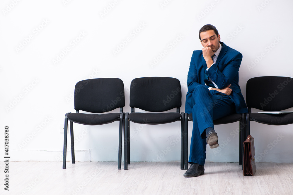 Young businessman waiting for an interview at hall Young businessman waiting for an interview at hall