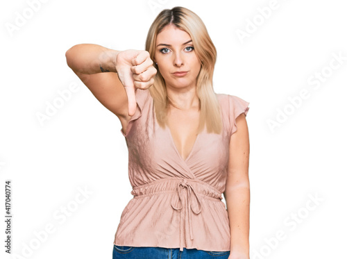 Young caucasian woman wearing casual clothes looking unhappy and angry showing rejection and negative with thumbs down gesture. bad expression. © Krakenimages.com