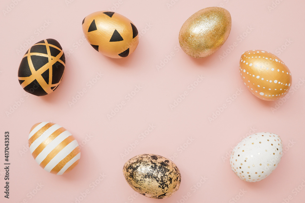 Frame of Easter golden decorated eggs on pastel pink background. Minimal easter concept. Happy Easter card with copy space for text. Top view, flatlay Frame of Easter golden decorated eggs on pastel pink background. Minimal easter concept. Happy Easter card with copy space for text. Top view, flatlay