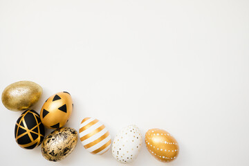 Frame of Easter golden decorated eggs isolated on white background. Minimal easter concept. Happy Easter card with copy space for text. Top view, flatlay