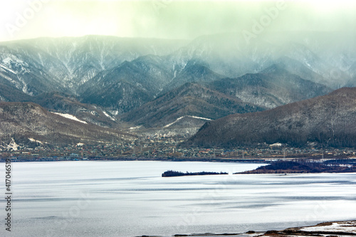  Lake baikal with mountains covered with fog / sky in clouds / autumn baikal