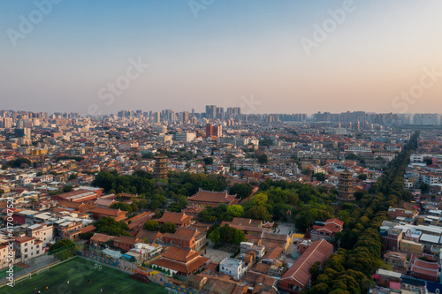 Aerial view of Kaiyuan Temple, the largest buddhist temple in Fujian Province, and West Street at dusk in Quanzhou, China © Sen