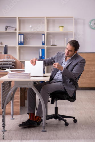 Young male employee working in the office