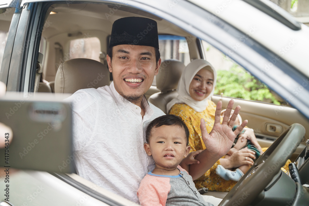 portrait of Muslim family travel by car and talk using video call on their phone