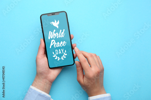 Female hands holding mobile...
