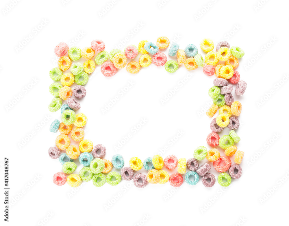 Frame made of tasty cereal rings on white background