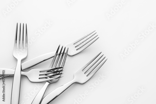 Stylish forks on light background
