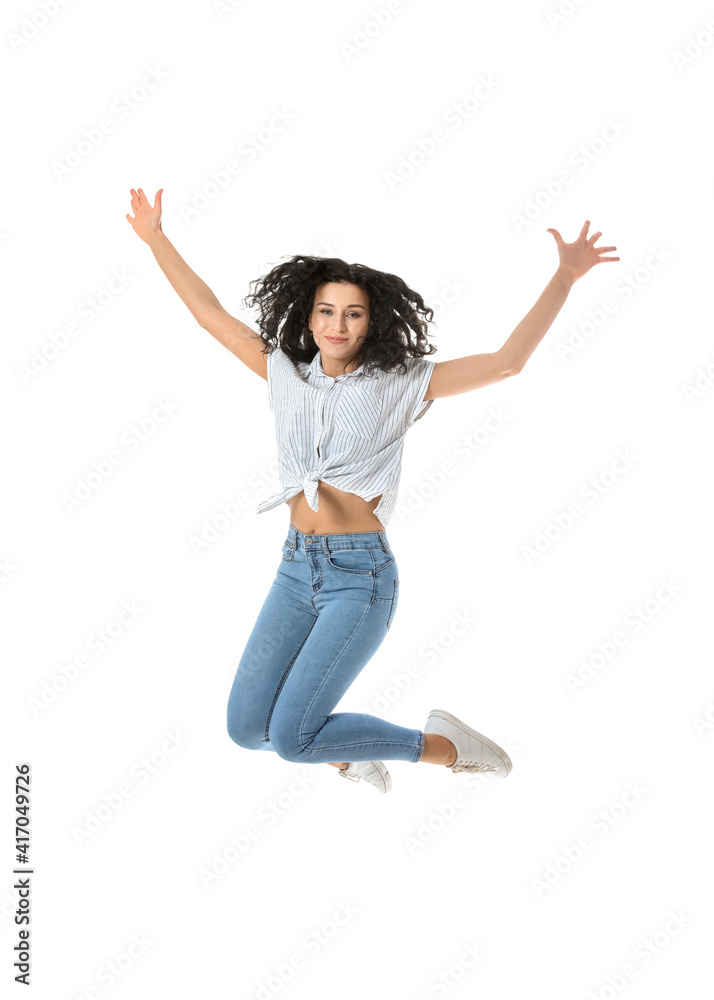 Jumping young woman against white background