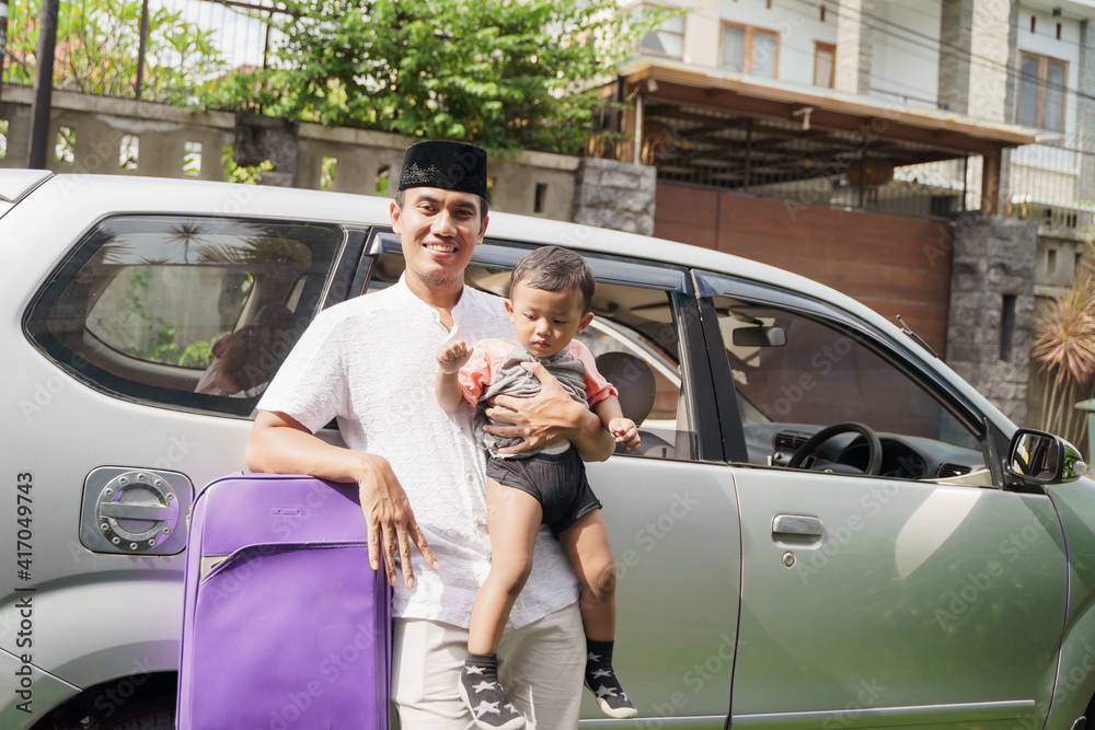 Muslim family travel by car during eid mubarak celebration. asian people going back to their hometown. father and son on a car trip