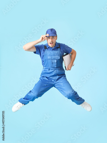 Jumping male worker on colo...