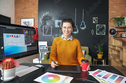 Young female designer worki...
