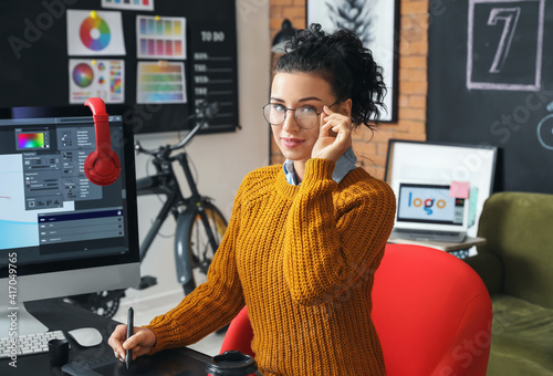 Young female designer worki...