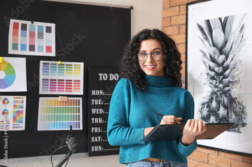 Young female designer worki...