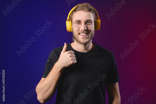 Handsome young man listenin...