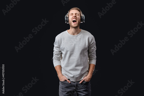 Emotional young man listeni...