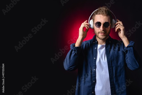 Handsome young man listenin...