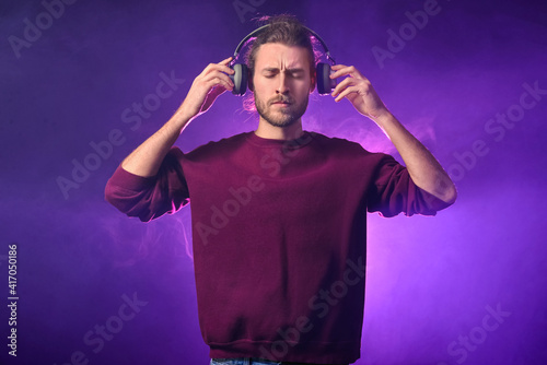 Handsome young man listenin...