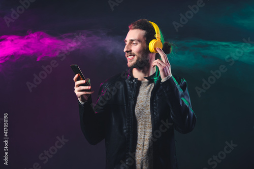 Handsome young man listenin...