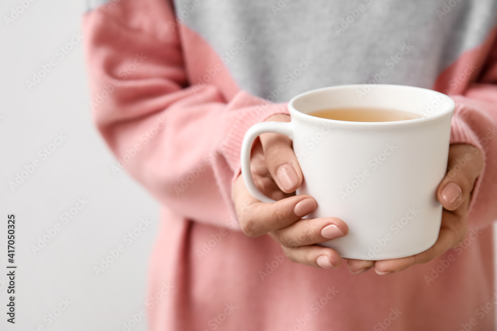 Woman with cup of hot tea, closeup Woman with cup of hot tea, closeup