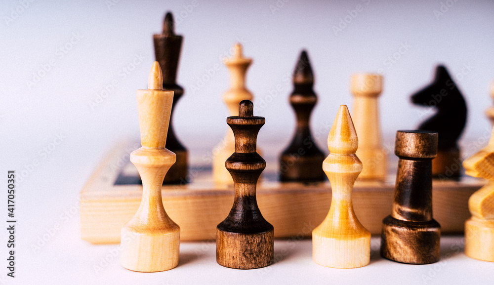 Close-up of chess on a gray background. Wooden chess pieces. Concept: the Board game and the intellectual activities Close-up of chess on a gray background. Wooden chess pieces. Concept: the Board game and the intellectual activities