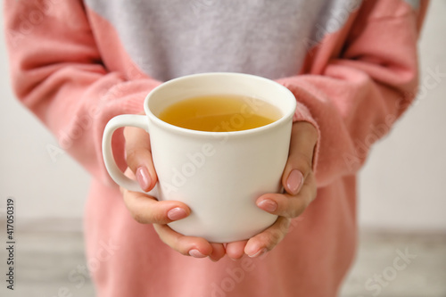 Woman with cup of hot tea, closeup