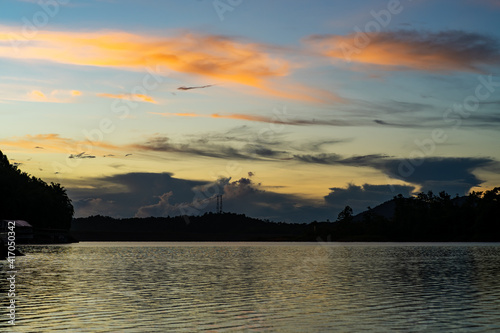 Golden hour sunrise in Kenyir Lake, Terengganu, Malaysia. © ellinnur