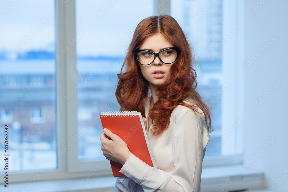 Business woman in office holding notepad in hands of documents Professional manager Business woman in office holding notepad in hands of documents Professional manager
