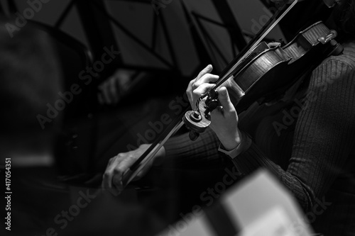  Hands of a musician playing the violin in black and white