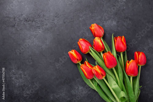 Wonderful spring tulips on a dark stone table. Valentine's day greetiong card. Top view. Copy space - Image