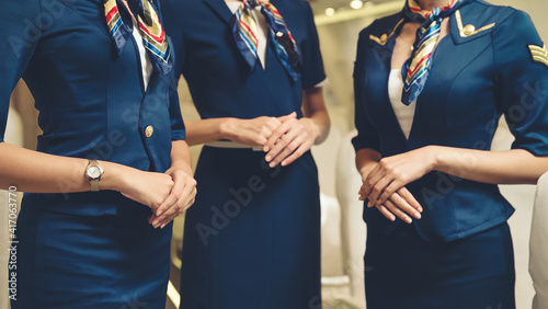 Photo Group of cabin crew or air hostess in airplane