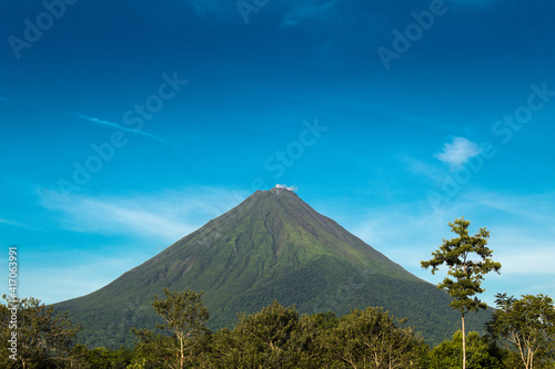 Arenal Volcano view in a sunny day with blue sky and green nature