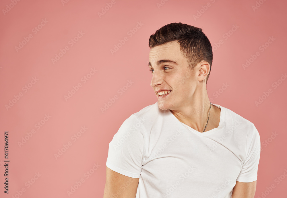 Cheerful man gestures with hand emotions white t-shirt pink background Cheerful man gestures with hand emotions white t-shirt pink background