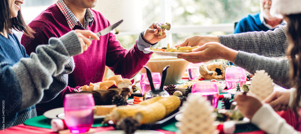 Fototapeta premium Portrait of happy big family celebrating having fun and eating food on lunch together enjoying spending time together at home