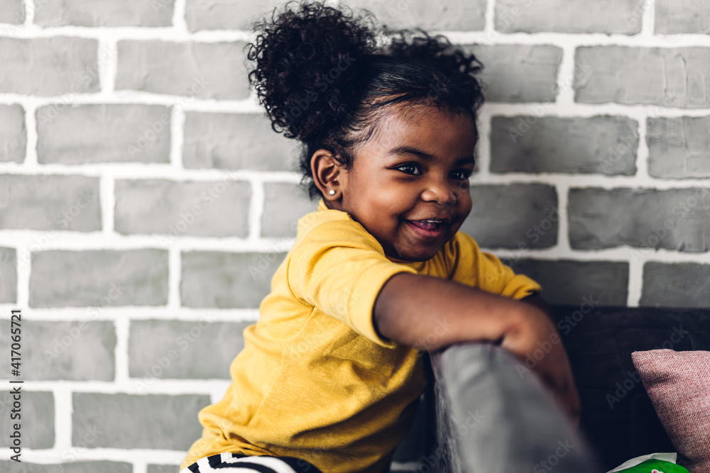Portrait of happy smiling little child african american girl at home