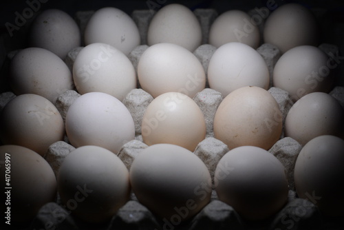 pile of chicken eggs on a dark background