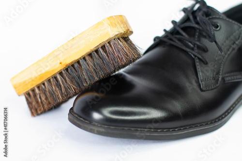 Shoe brush is shoe shine black classic men's shoes on a white background photo
