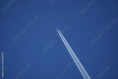 Jet plane caught in the air with a blue background.