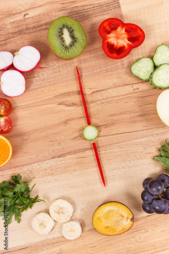 Fototapeta Naklejka Na Ścianę i Meble -  Fruits and vegetables in shape of clock, concept of time for healthy eating containing minerals