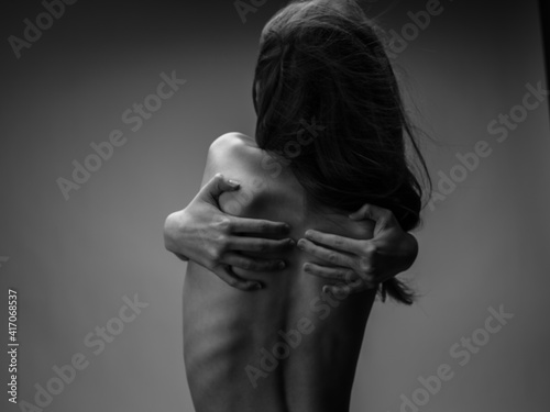 Woman black and white photography portrait rear view touching back with hands