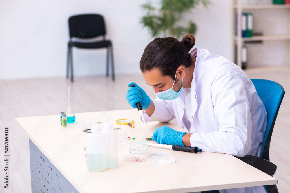 Young male chemist working in the lab during pandemic Young male chemist working in the lab during pandemic