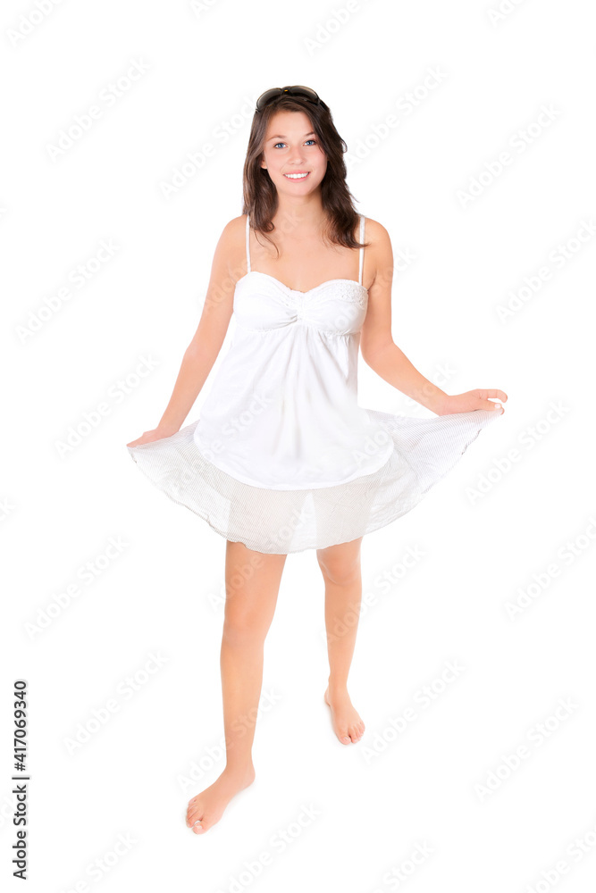 Full length fashion portrait of a happy young woman wearing a short summer skirt and a top, isolated in front of white studio background Full length fashion portrait of a happy young woman wearing a short summer skirt and a top, isolated in front of white studio background