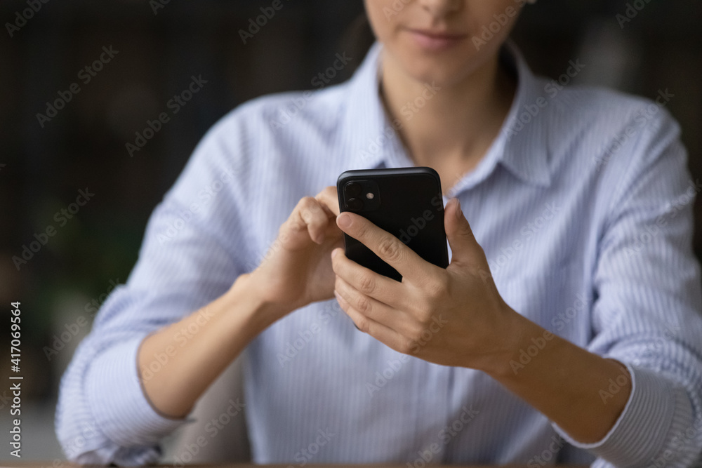 Crop close up of young Caucasian businesswoman use modern smartphone text or message with client partner online. Woman hold look at cellphone screen browse internet. Technology, communication concept. Crop close up of young Caucasian businesswoman use modern smartphone text or message with client partner online. Woman hold look at cellphone screen browse internet. Technology, communication concept.