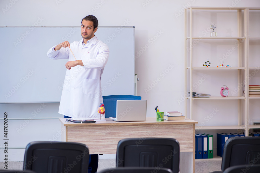 Young male doctor giving seminar in the classroom
