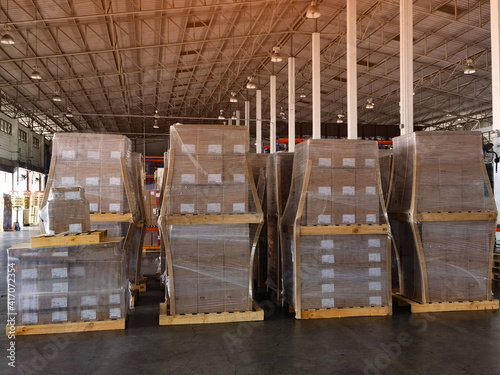 Shipment cartons box on pallets and wooden case on hand lift in interior warehouse cargo for export and sorting goods in freight logistics and transportation industrial, delivery service