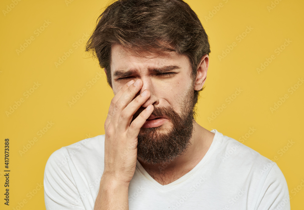 Upset guy crying on a yellow background and gesturing with his hands Upset guy crying on a yellow background and gesturing with his hands