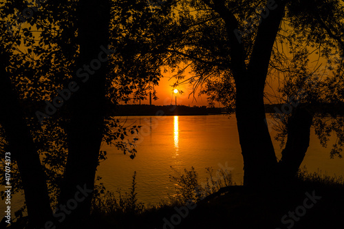 The sun over the chimney on the Romantic Beach in Warsaw, Poland