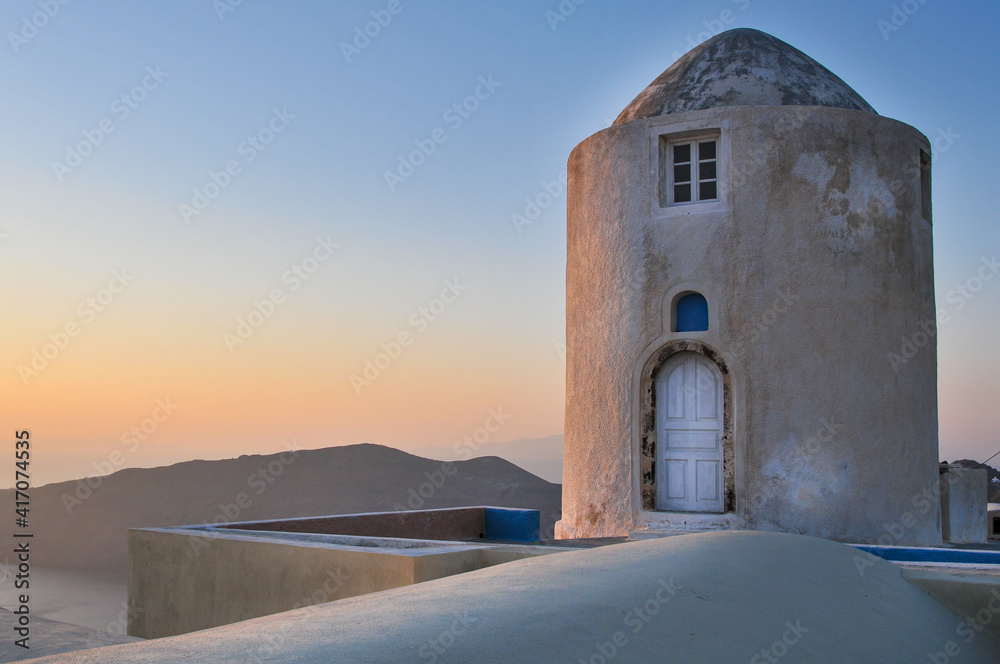 Greek white and blue minimal architecture at sunset. Fira Santorini island, Greece.